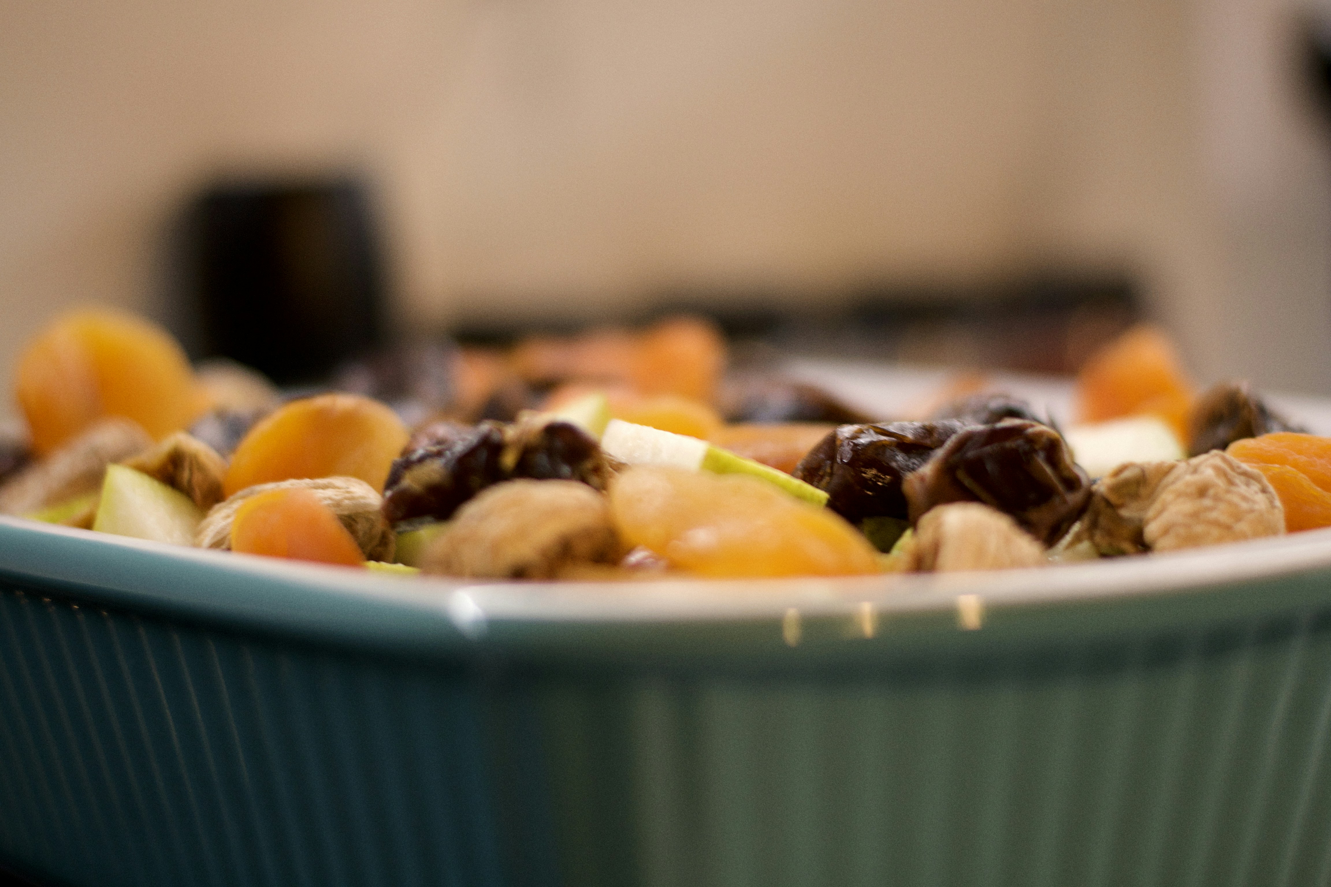 a close up of a bowl of fruit and nuts