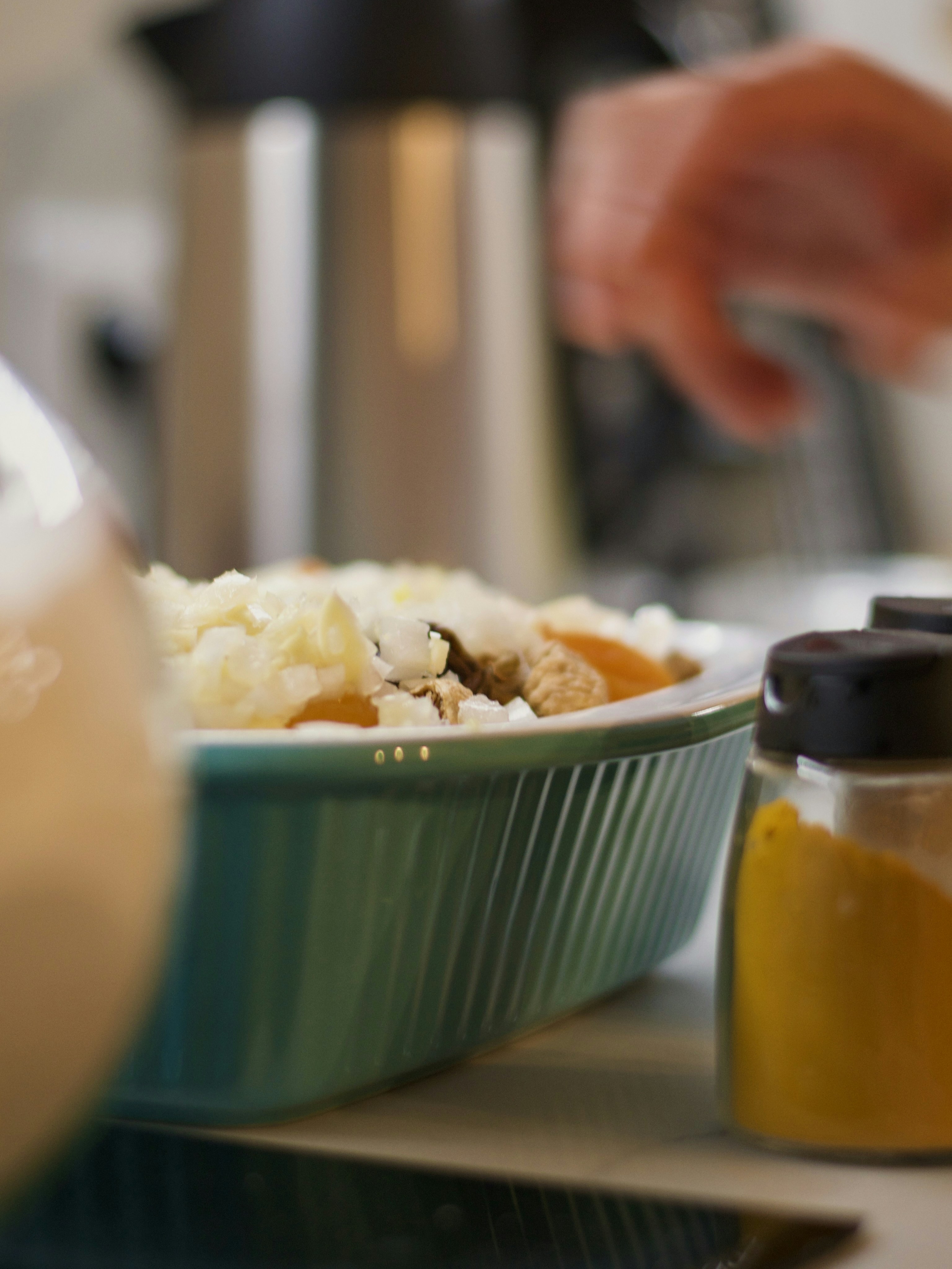 a person preparing food in a green bowl