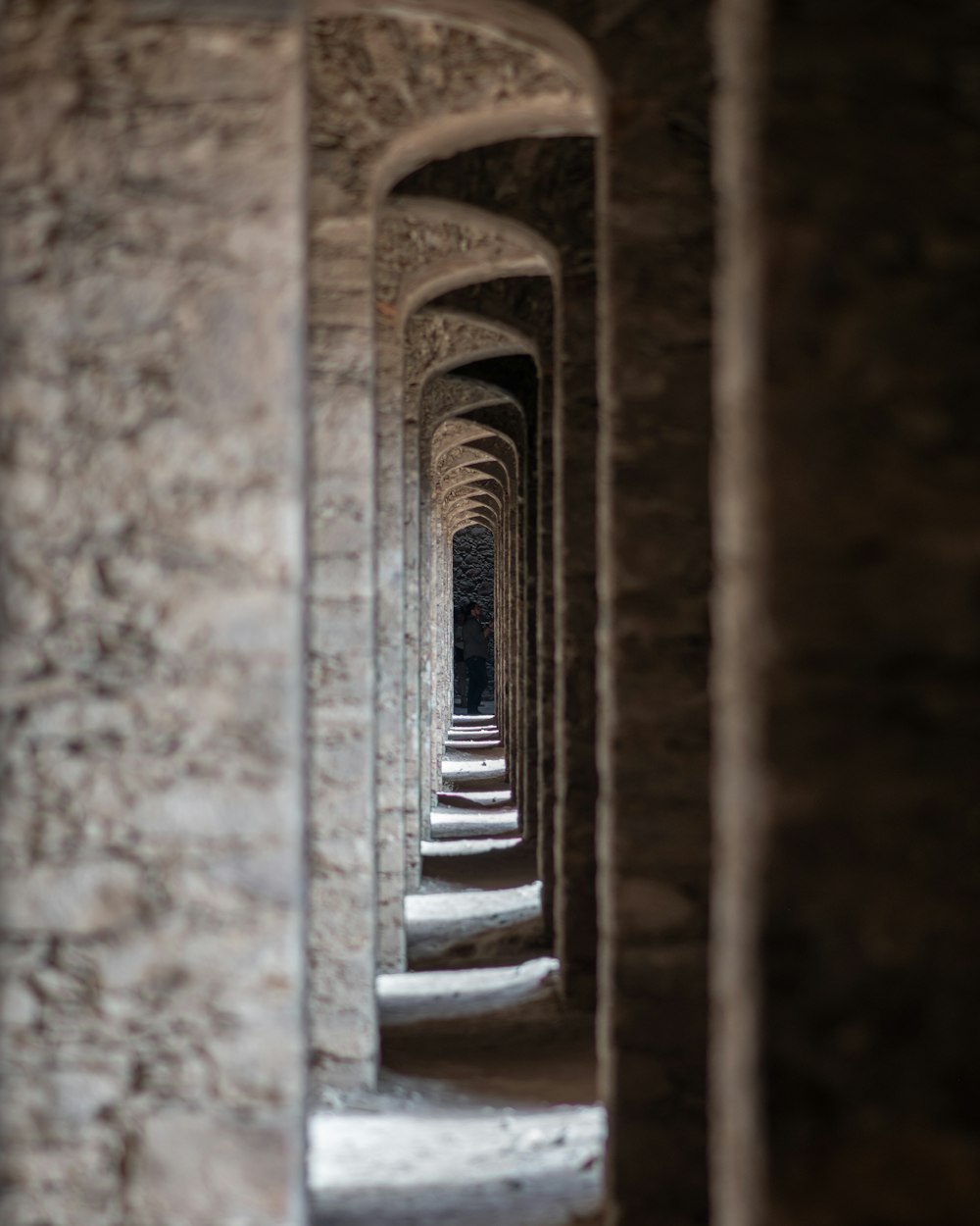 a long row of arches in a stone building