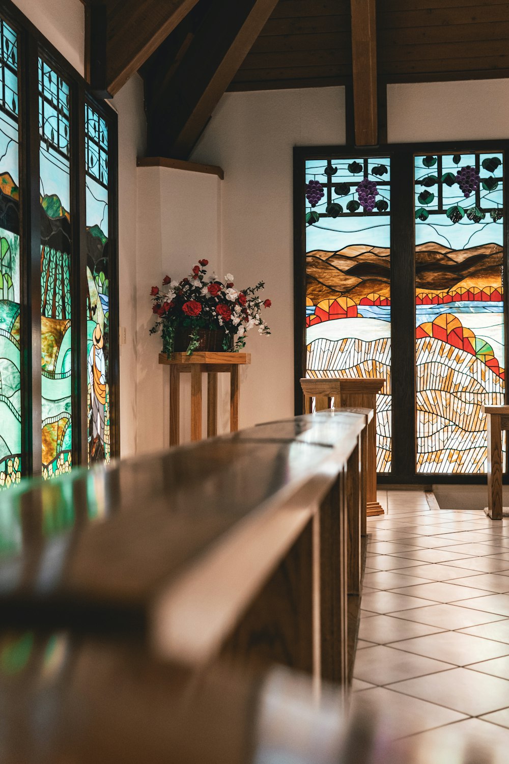 a church with stained glass windows and a bench