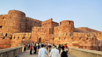 a group of people walking across a bridge