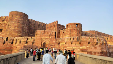 a group of people walking across a bridge