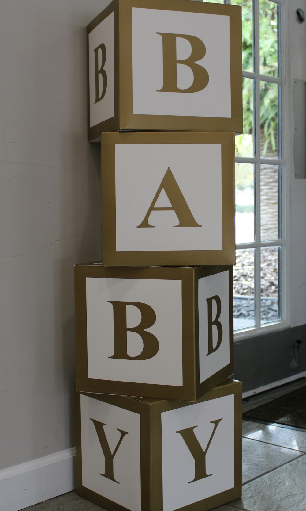 a stack of blocks with the letters b, b, and y on them