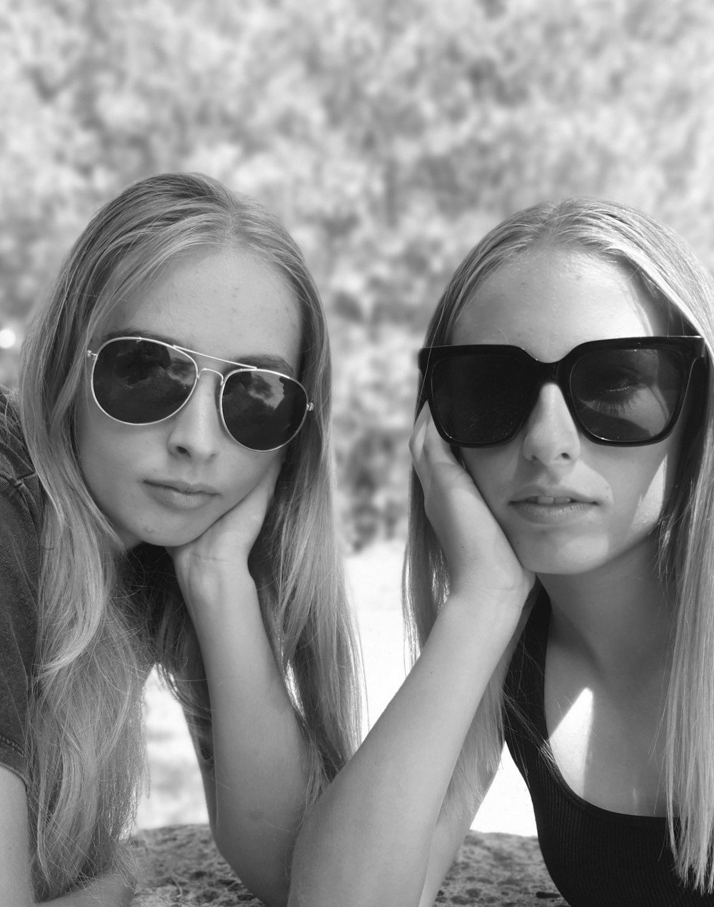 two beautiful young women sitting next to each other