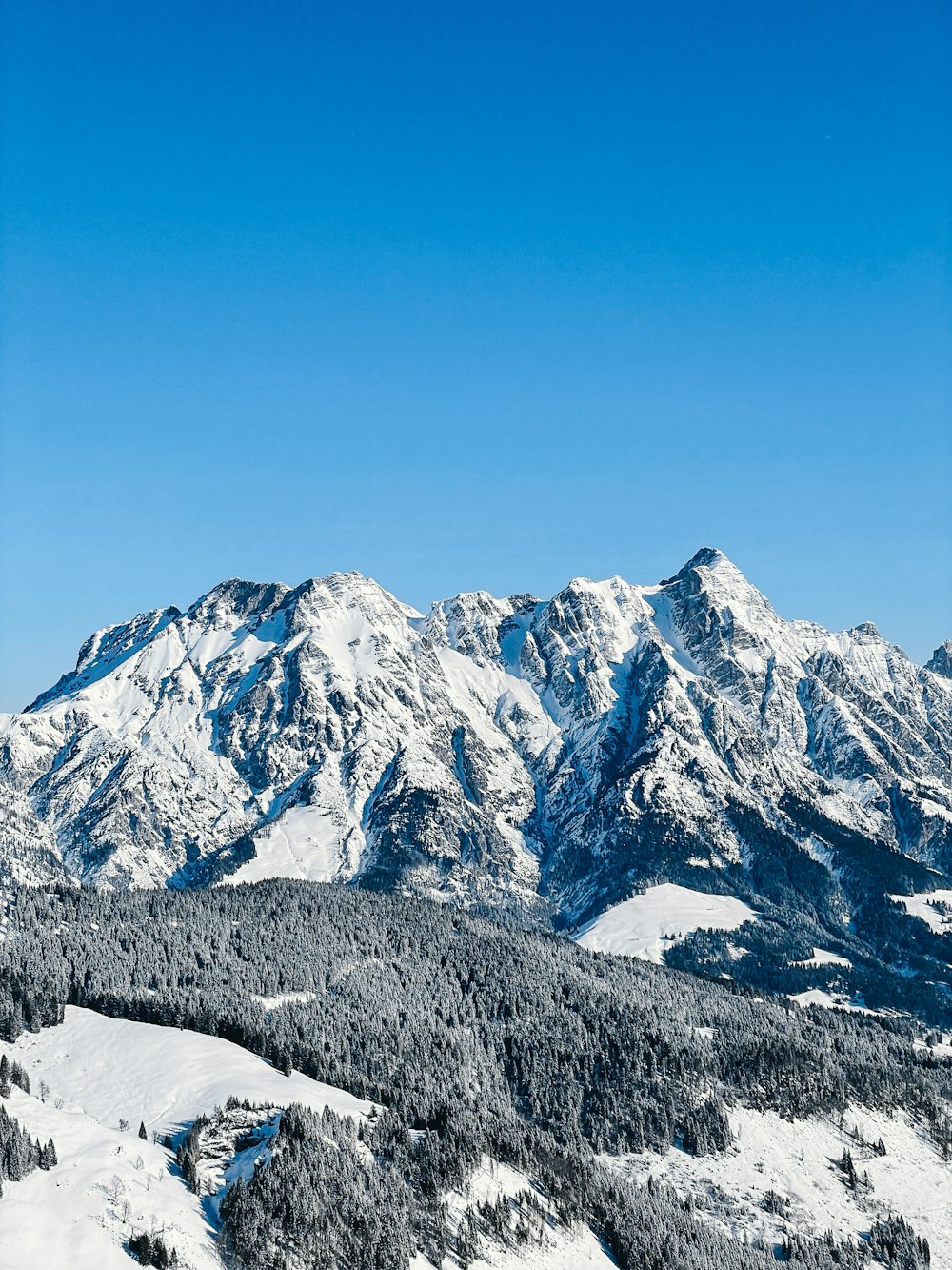 a view of a snowy mountain range from a ski slope