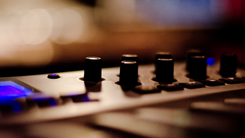 a close up of a sound board with knobs