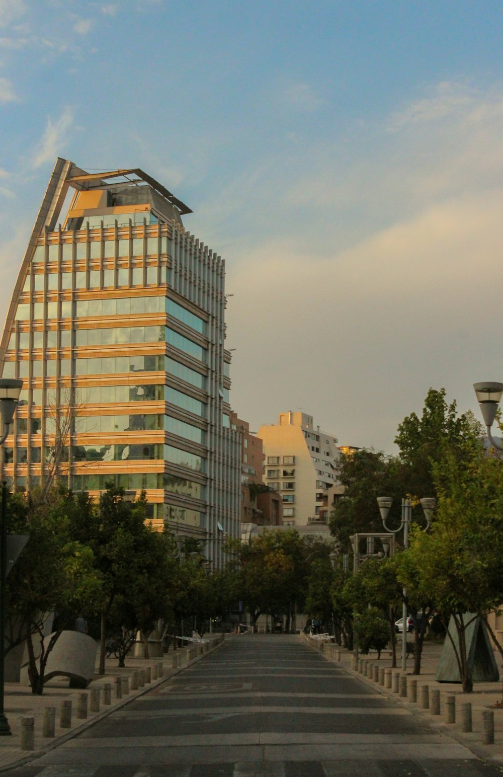 a city street lined with tall buildings and trees