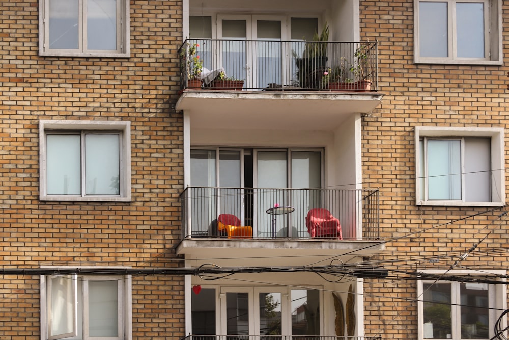 a red fire hydrant sitting on the side of a building