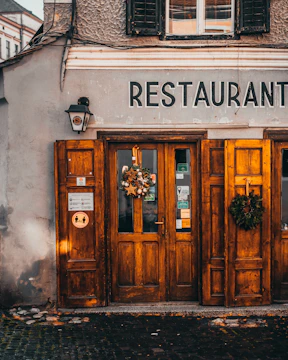 the front of a restaurant with wooden doors