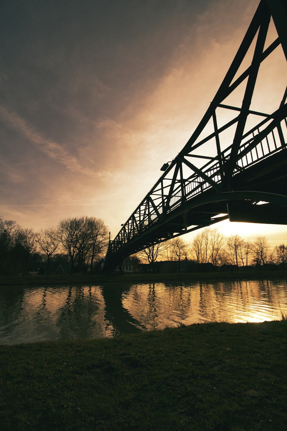 a bridge over a body of water at sunset