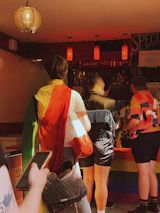 Smiling diverse group of customers reflecting the shop’s LGBTQ+ friendly community spirit.