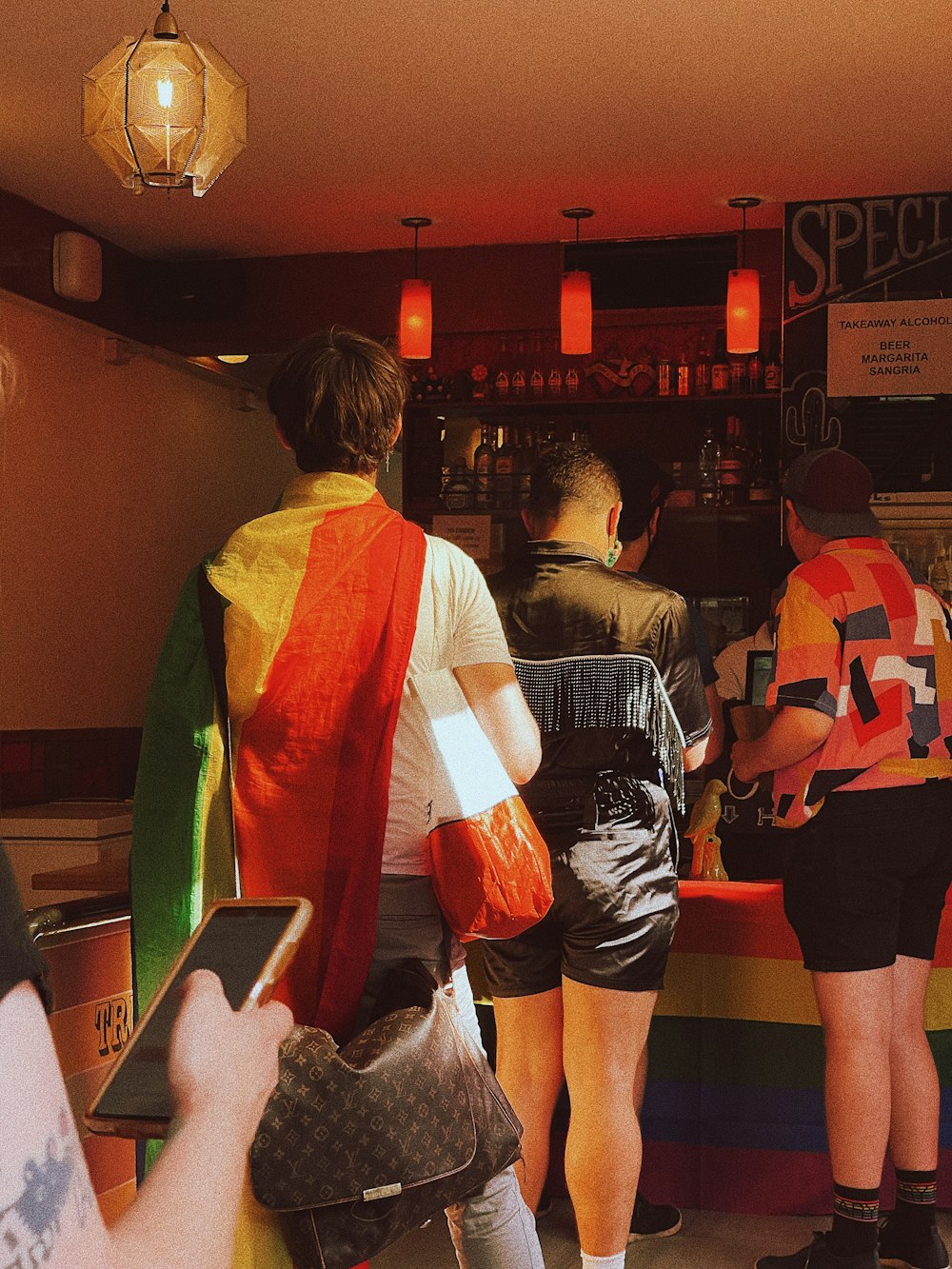 a group of people standing around a bar