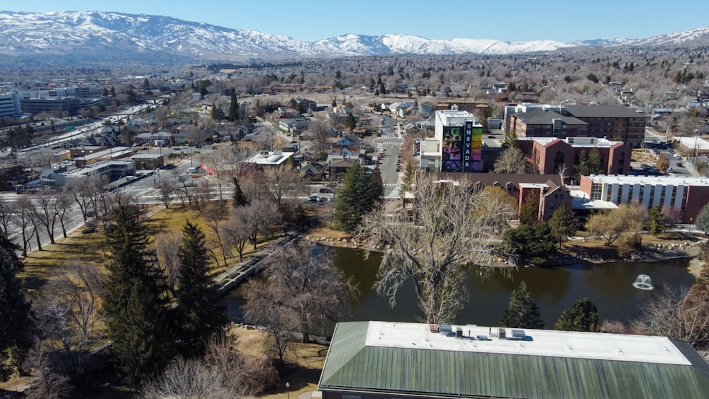 an aerial view of a city with mountains in the background