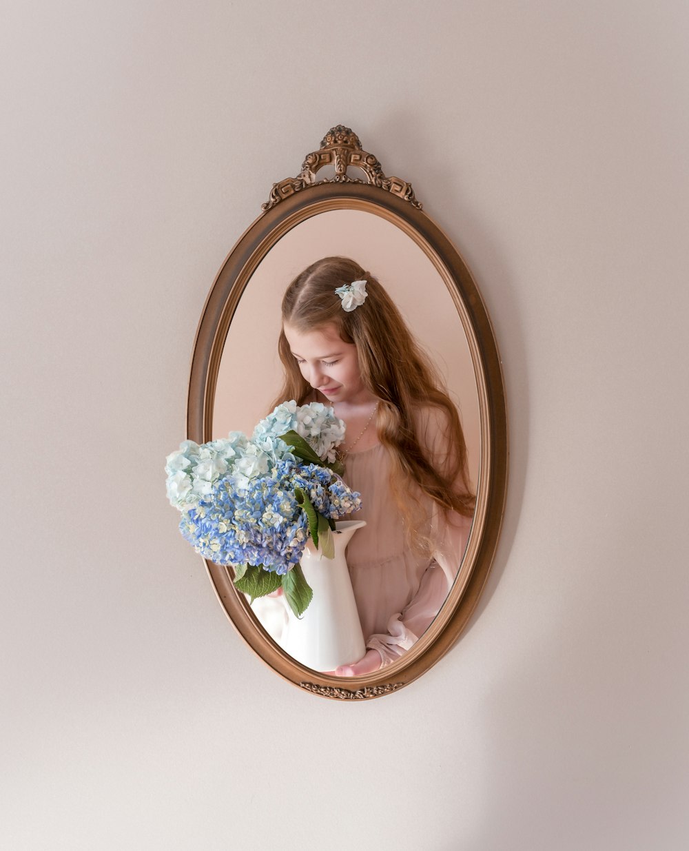 a woman holding a bouquet of flowers in front of a mirror