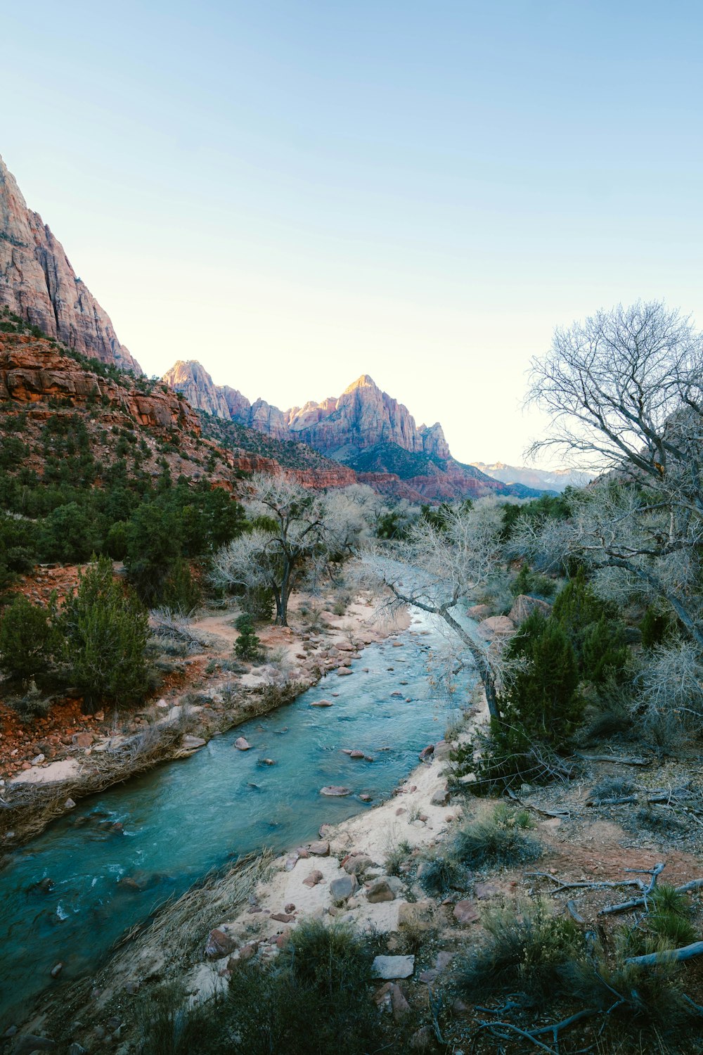 a river running through a valley surrounded by mountains