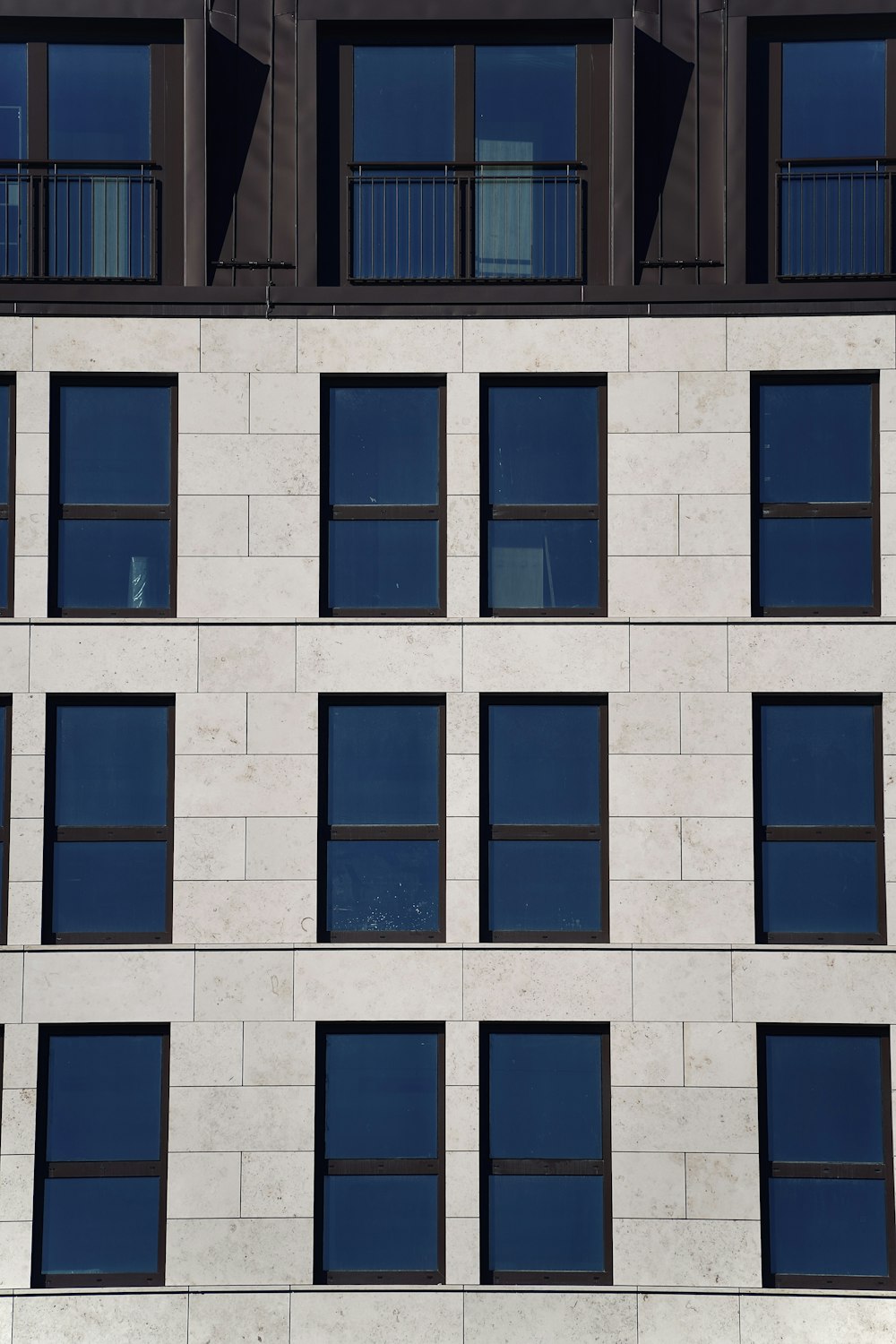 a building with many windows and a clock on the side of it