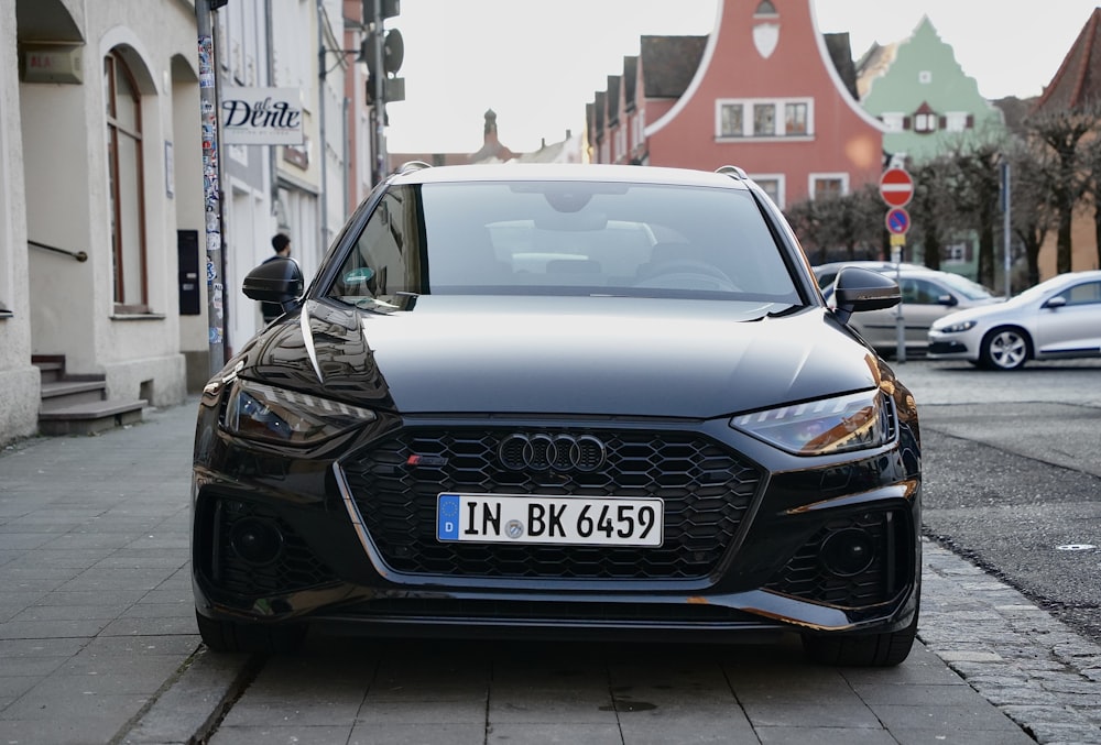 a black car parked on the side of the road