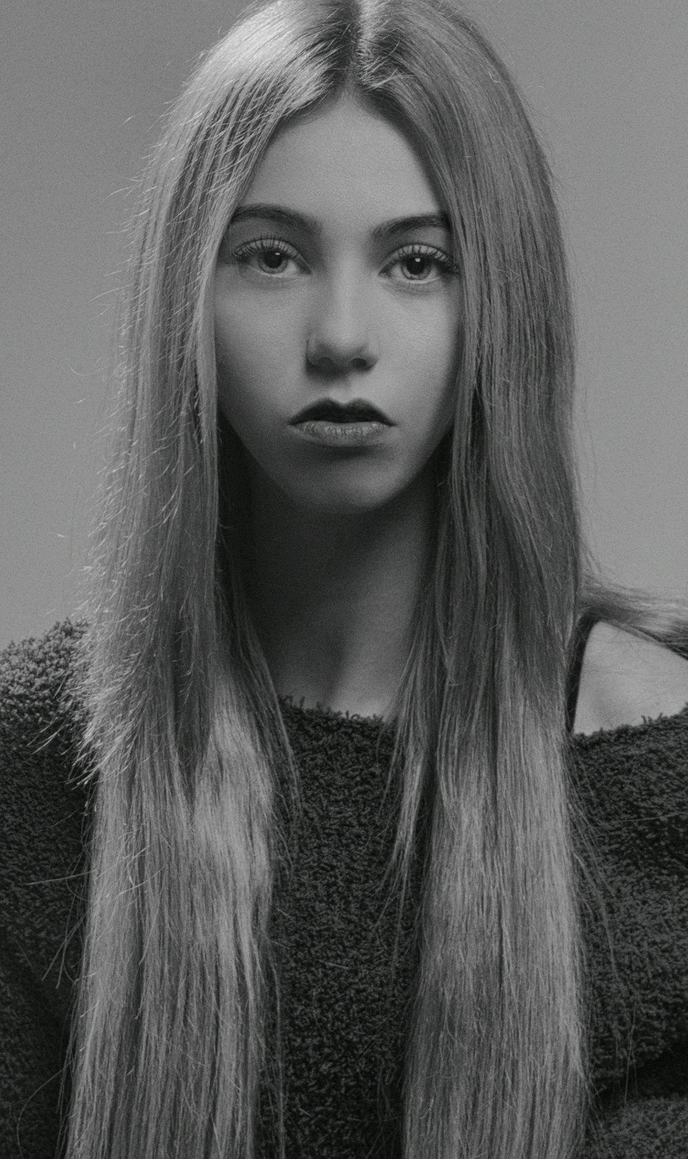 a black and white photo of a woman with long hair