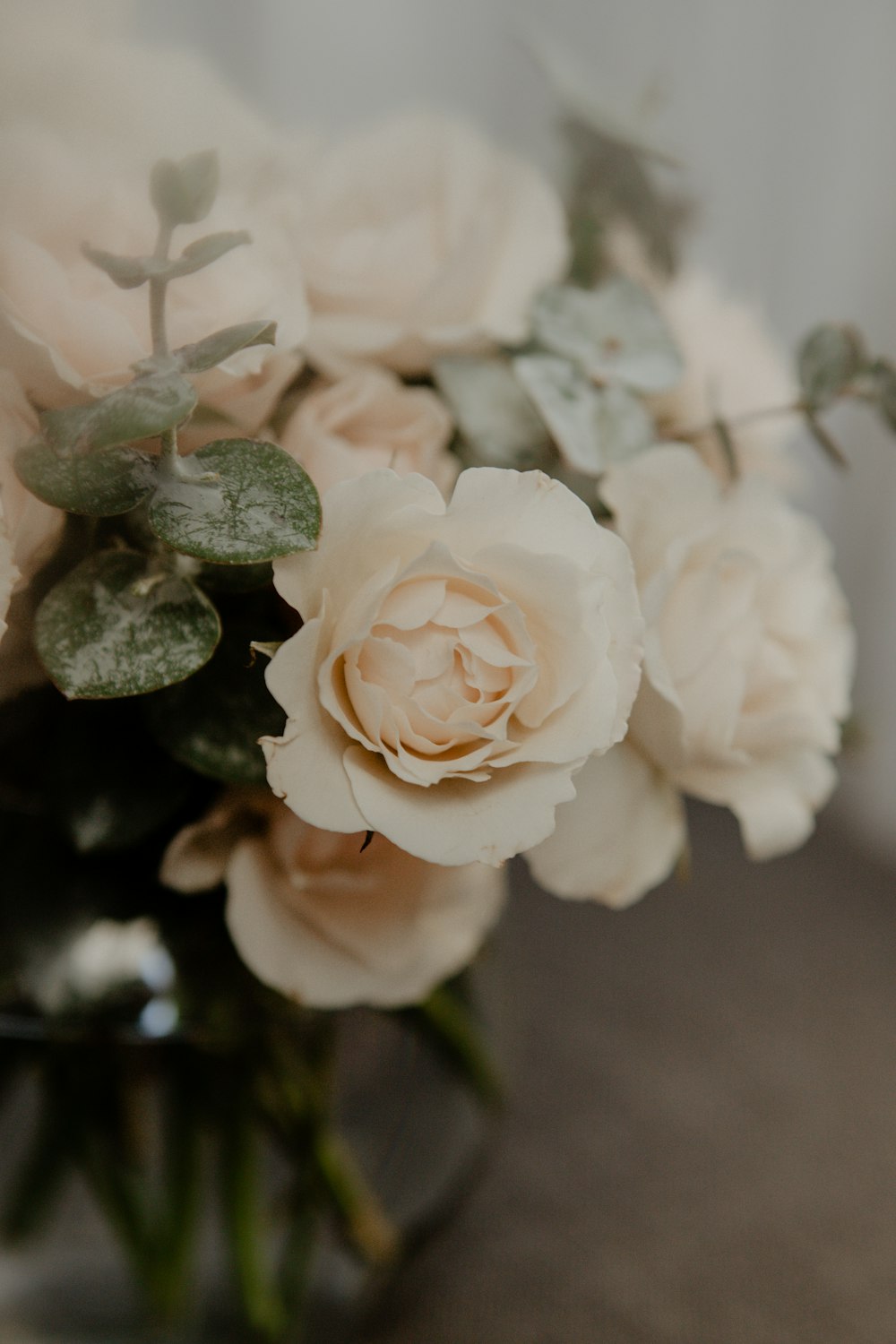 a vase filled with white flowers on top of a table