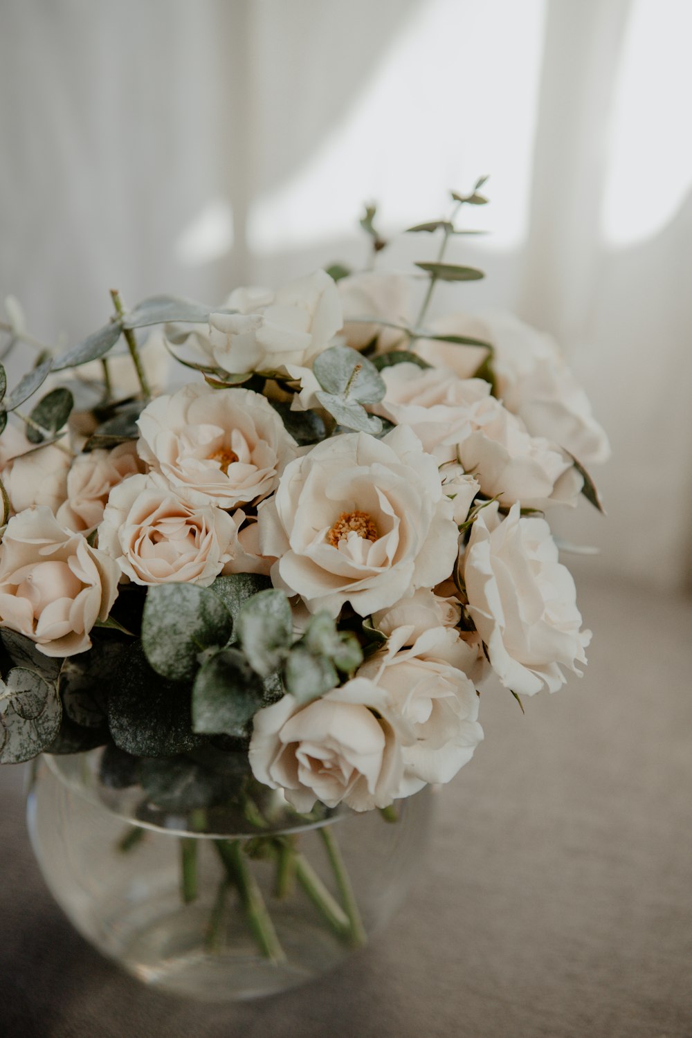 a vase filled with lots of white flowers