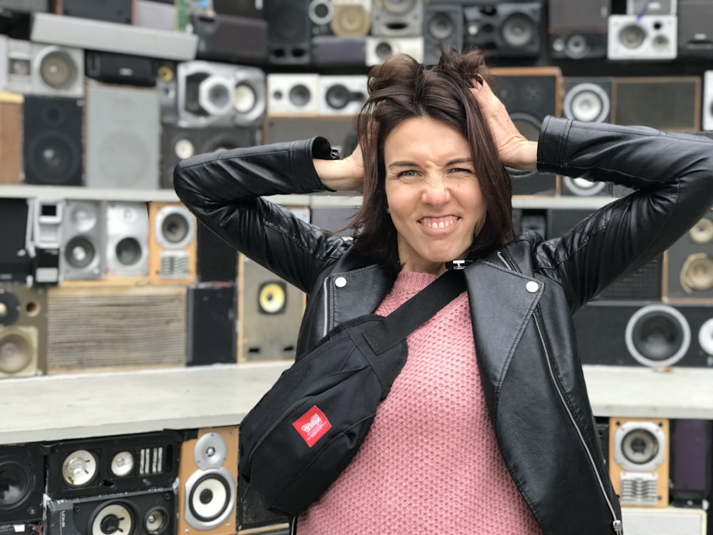 a woman standing in front of a wall of speakers