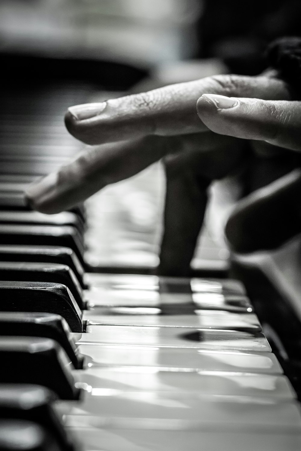 a close up of a person's hands on a piano