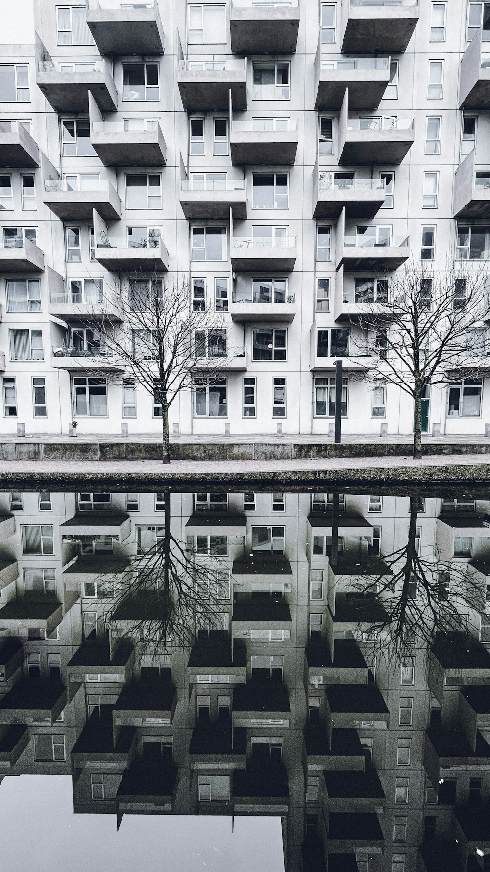 a reflection of a building in a pool of water