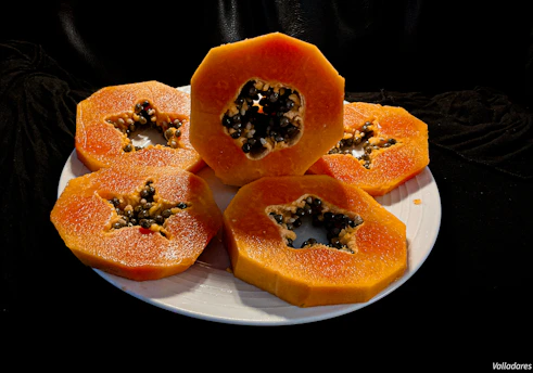 a white plate topped with cut up pumpkins