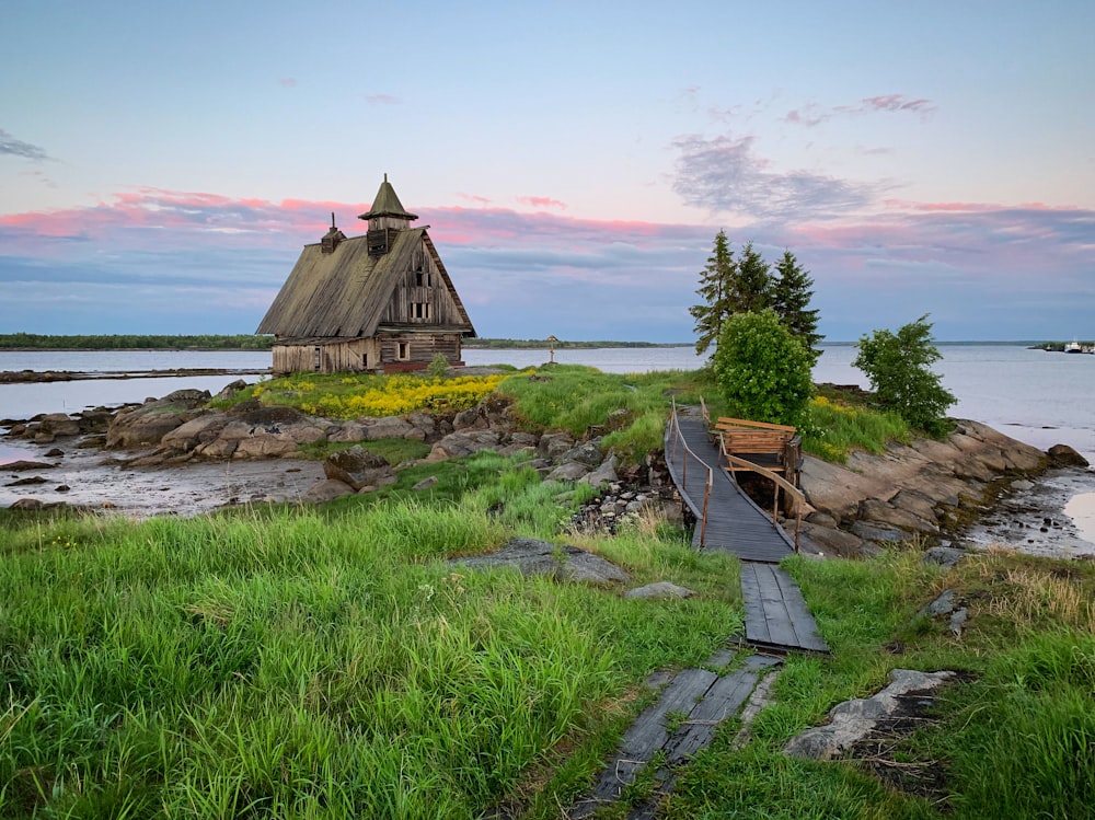 a house on a small island with a walkway leading to it