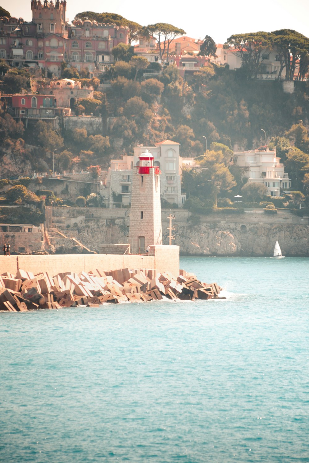 a light house sitting on top of a body of water