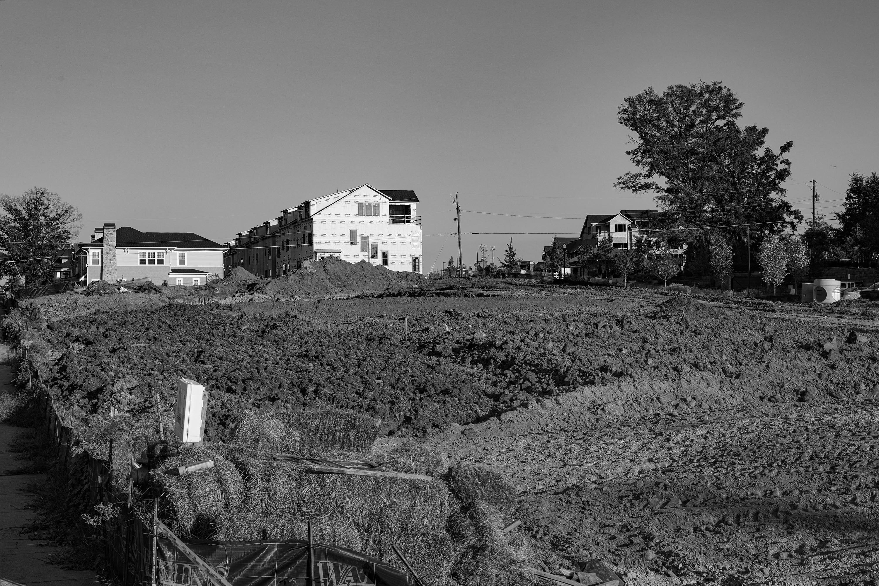 a black and white photo of a house on a hill