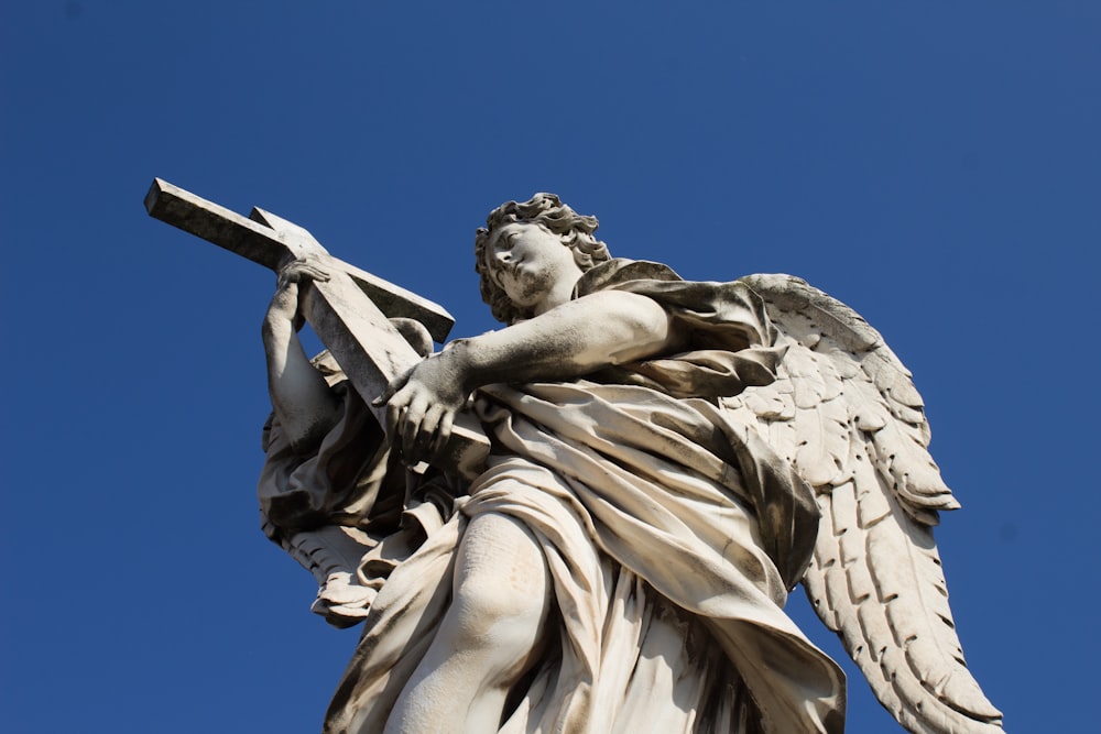 a statue of an angel holding a cross