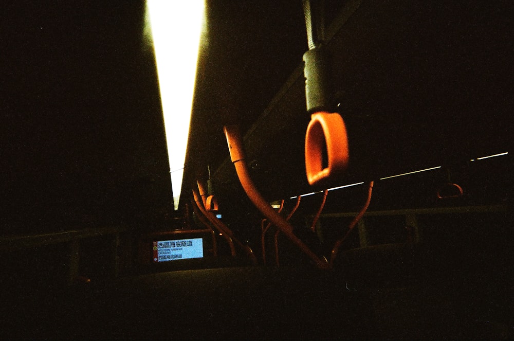 a street light in the dark with a cell phone in front of it