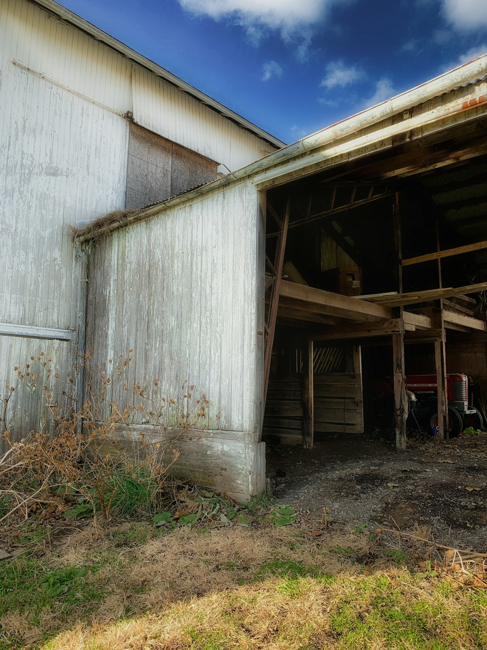 an old barn with a broken down door