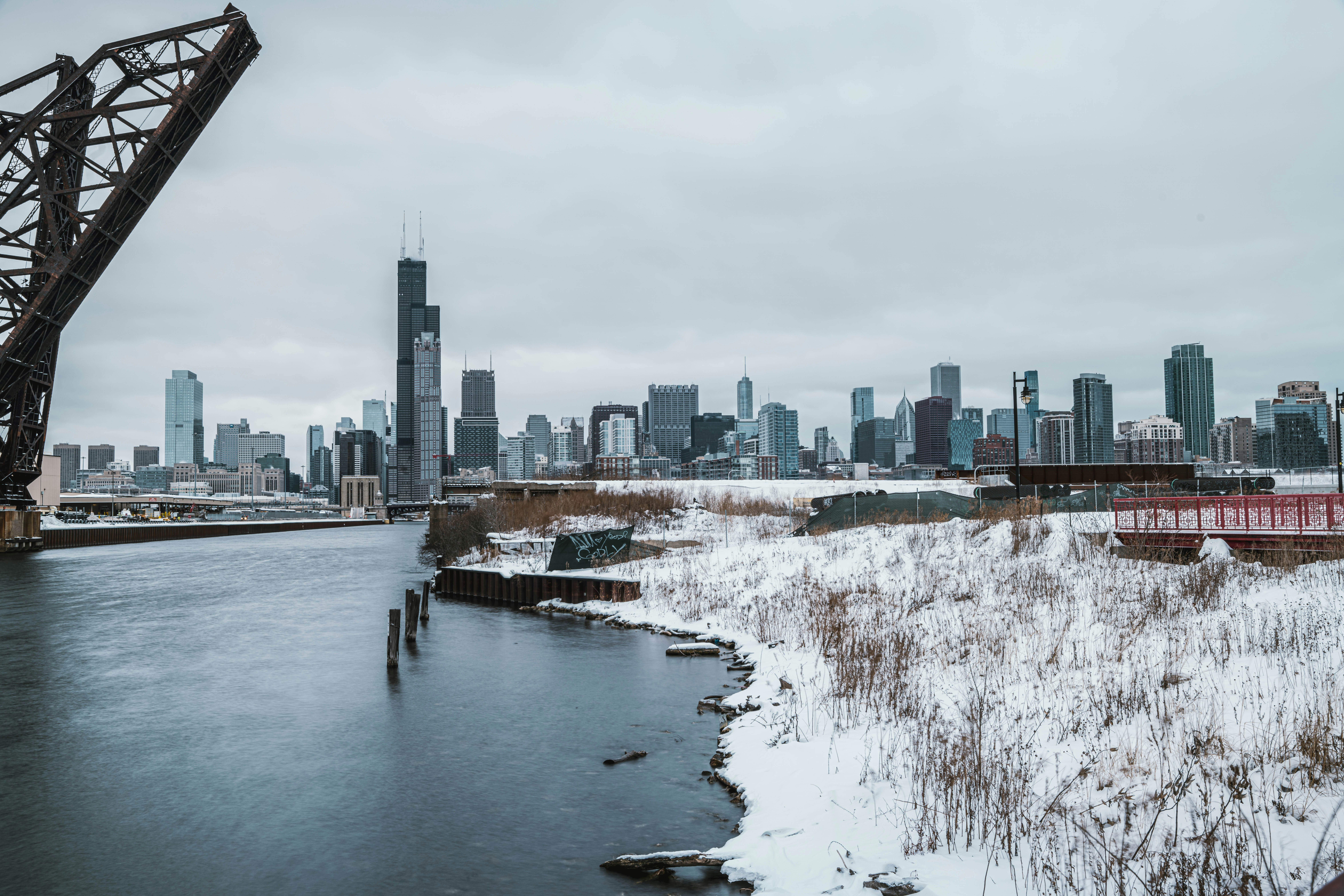 a bridge over a body of water with a city in the background