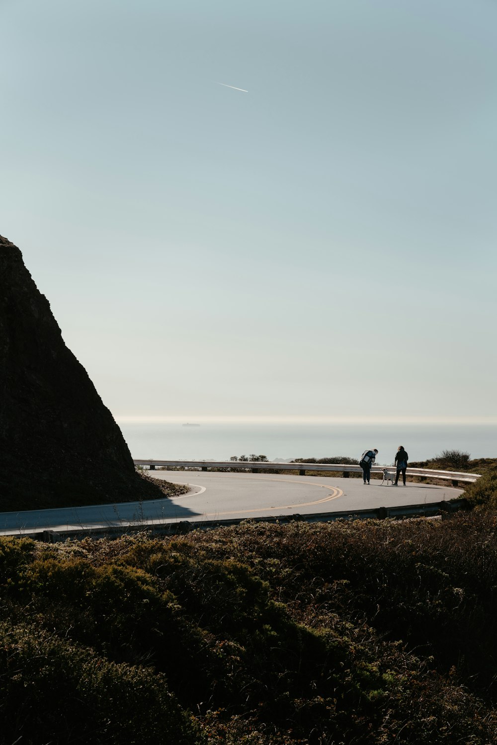 a couple of people that are walking down a road