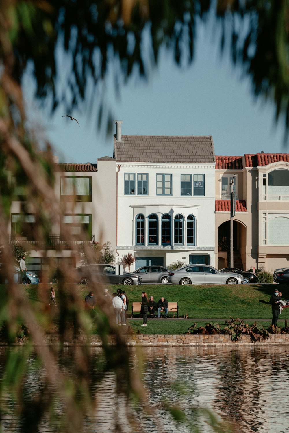 a large white house sitting next to a body of water