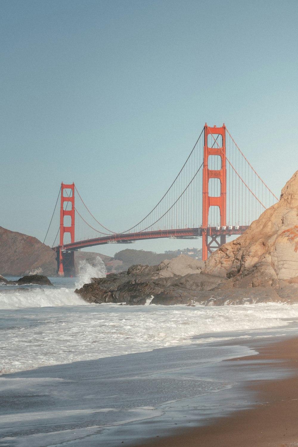 a view of the golden gate bridge from the beach