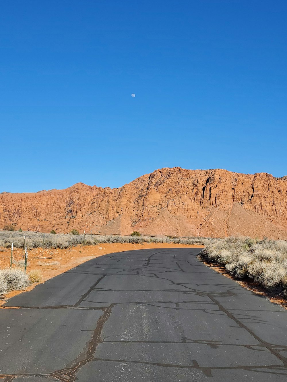 an empty road in the middle of a desert