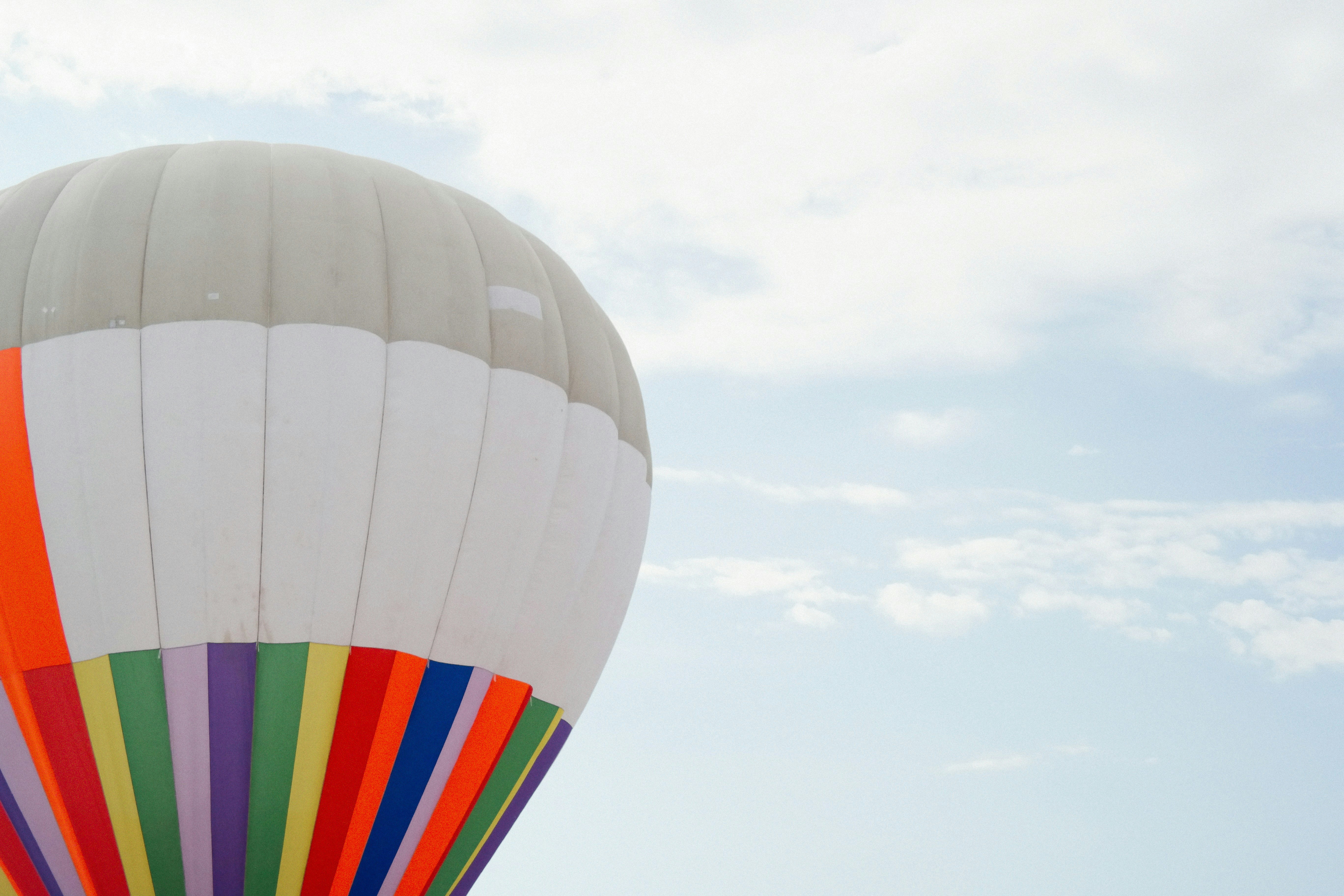 A multicolored hot air balloon flying in the sky photo – Free Grey ...