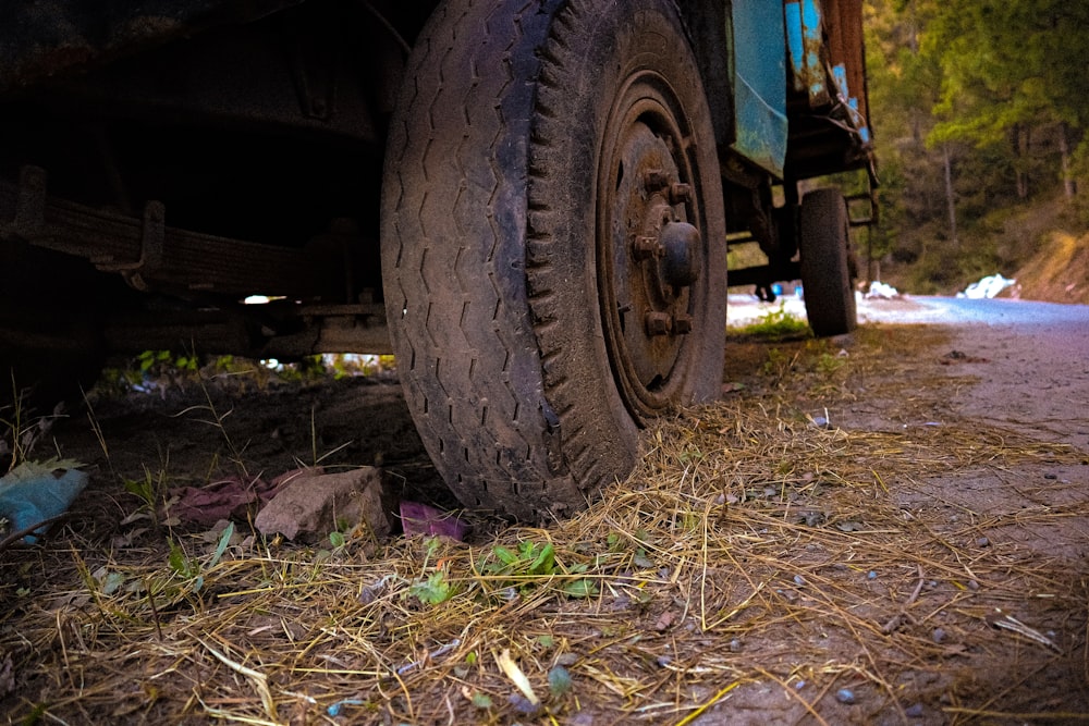 a close up of a truck tire on a dirt road