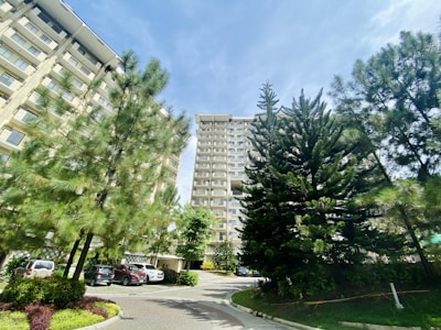 A well-maintained residential building with clean facades and neat landscaping under a bright sky.
