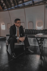 a man in a suit and tie sitting on a bench