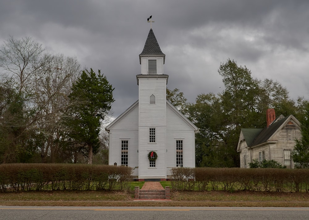 a white church with a wreath on the front of it