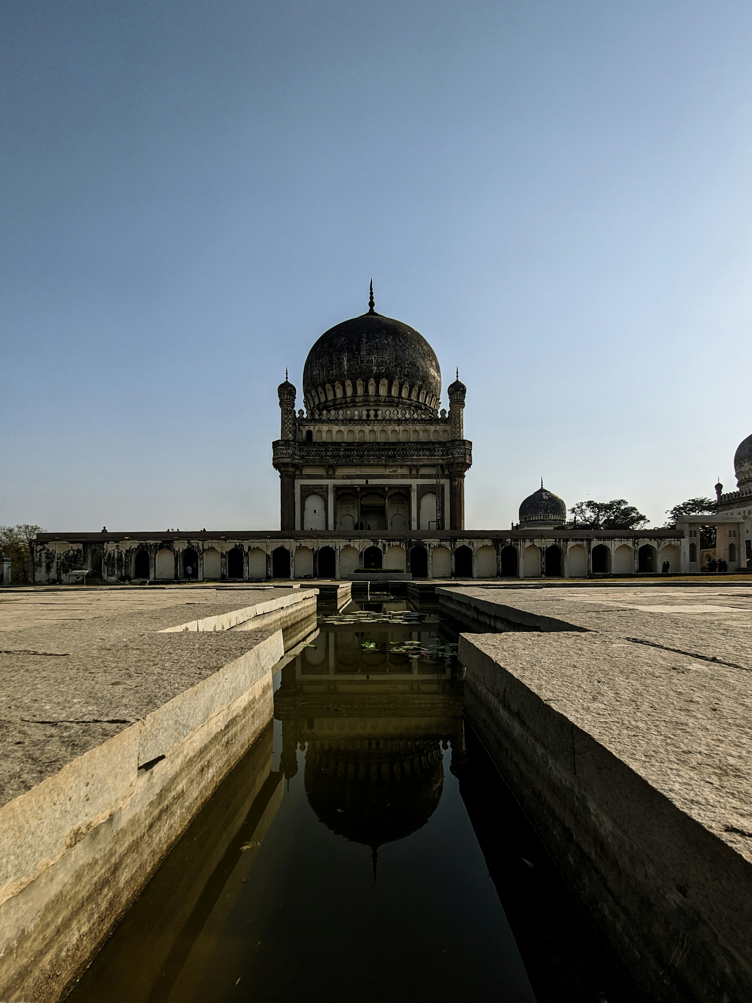 a large building with a large pond in front of it