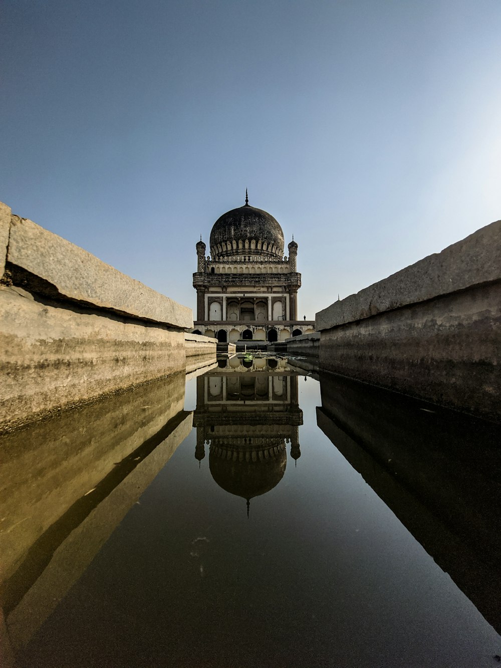 a reflection of a building in a body of water