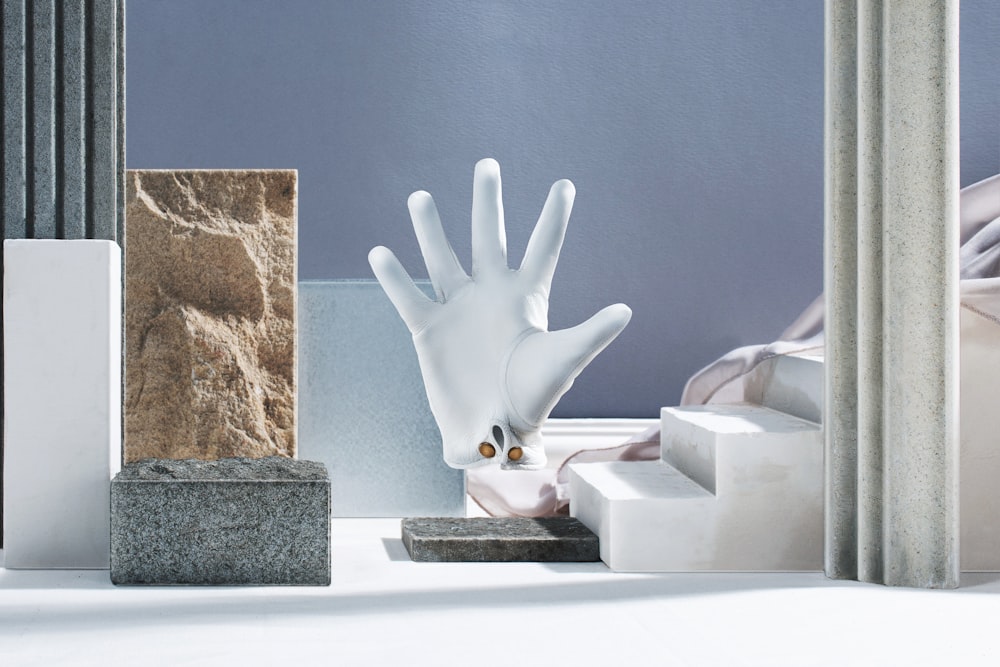 a sculpture of a hand reaching out of a box