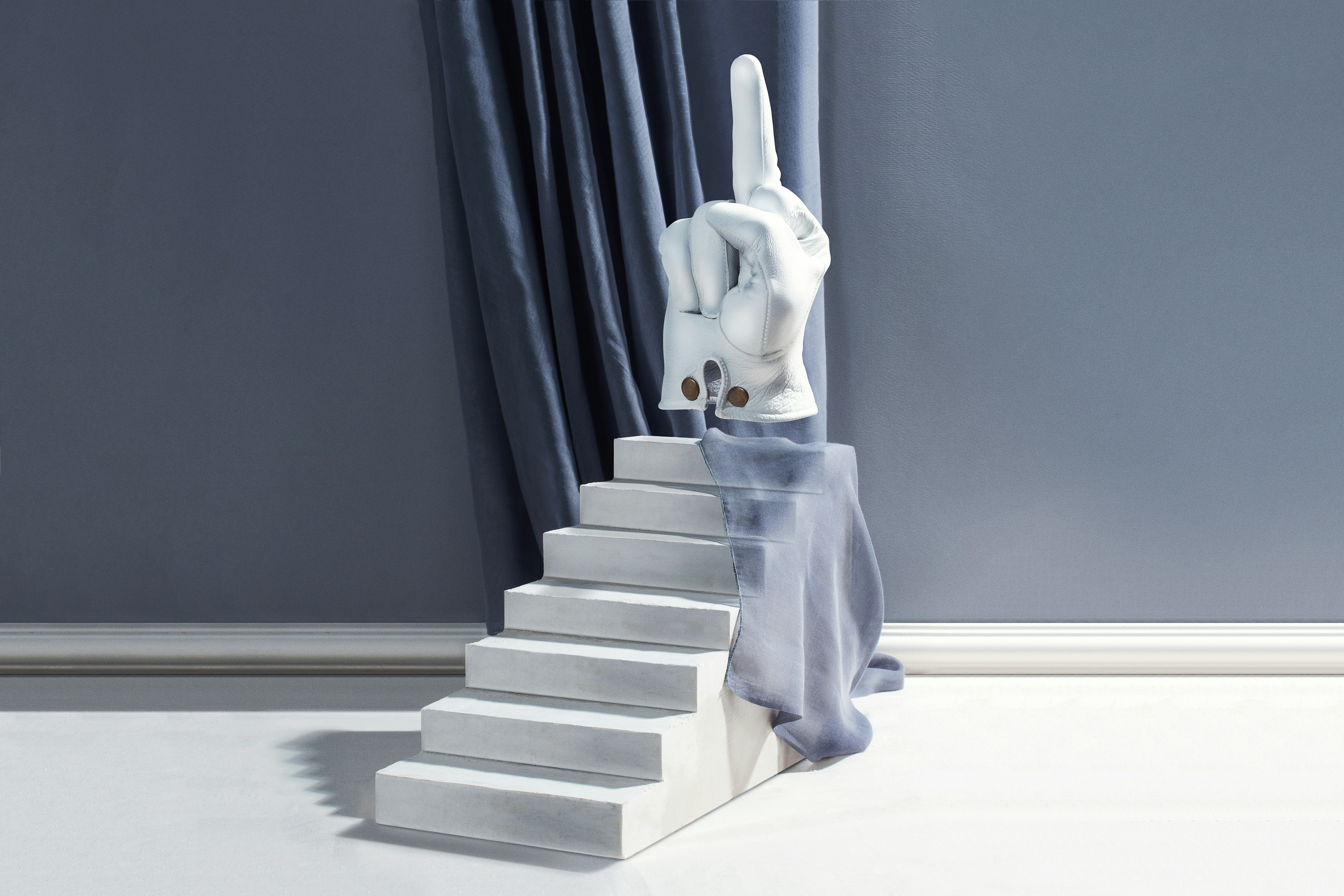 a white rabbit statue sitting on top of a set of stairs