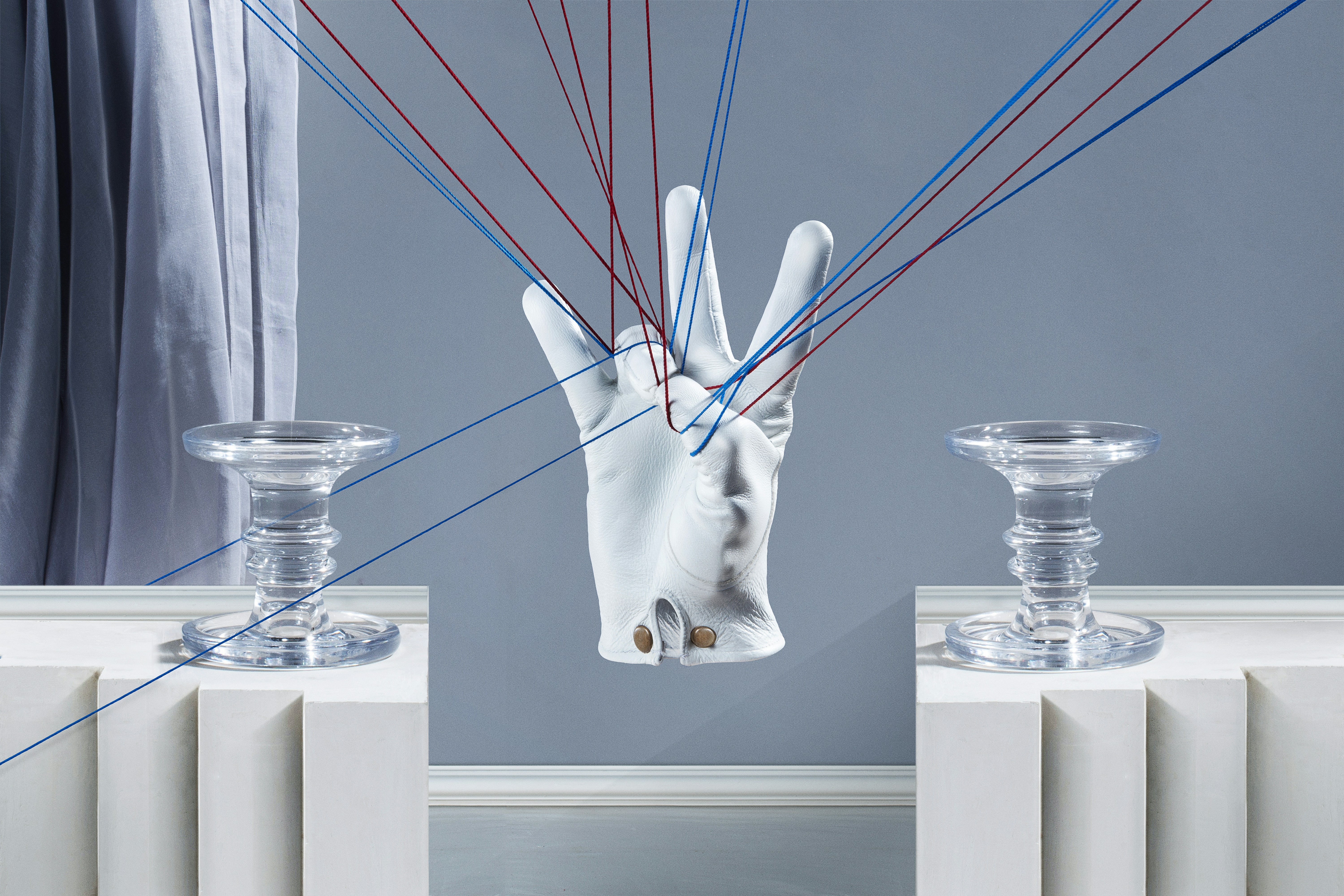 a pair of hands holding a string in front of a mirror