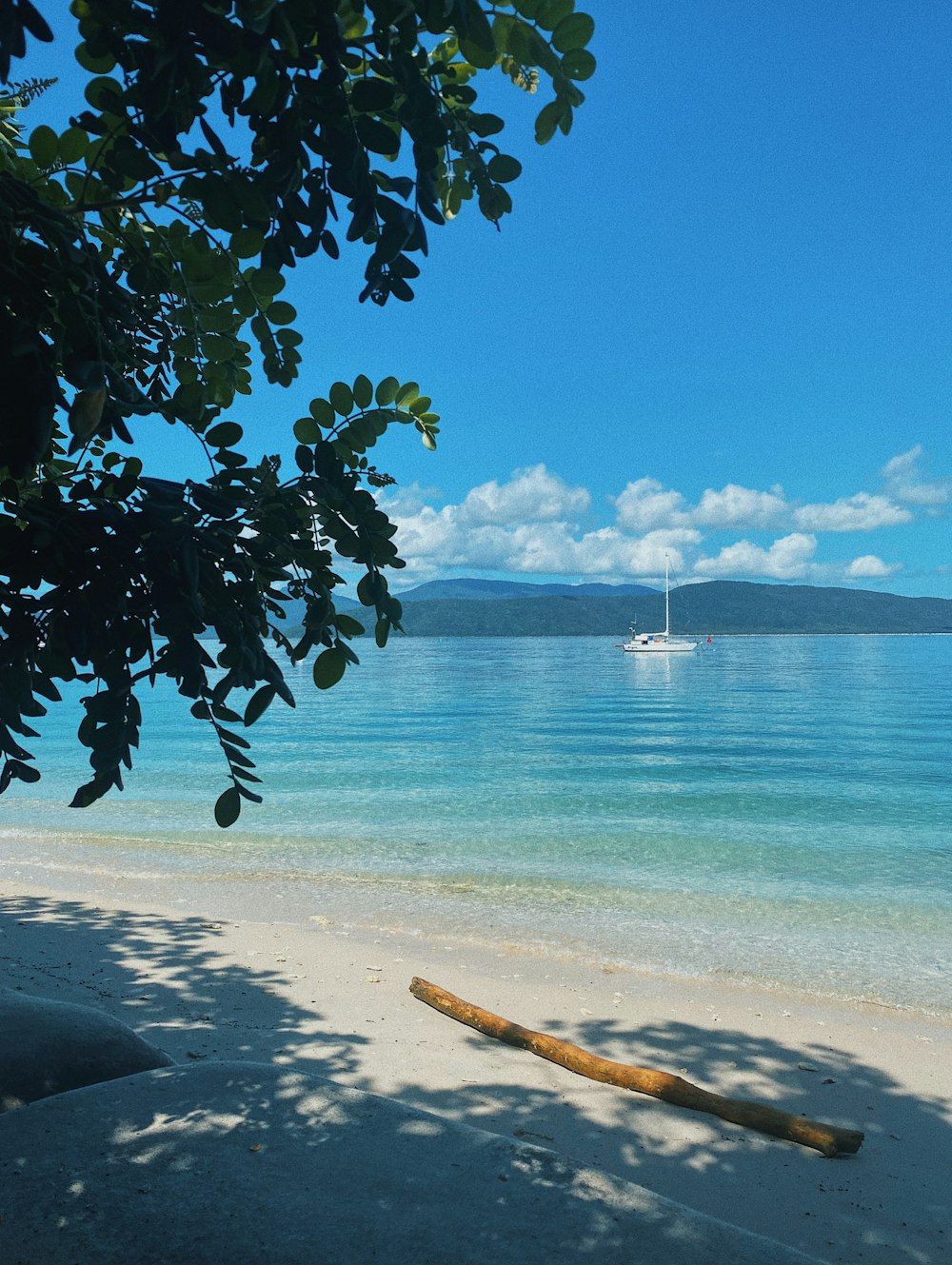 a boat is out on the water near a beach